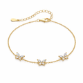 Gold bracelet with butterfly-shaped charms on a white background