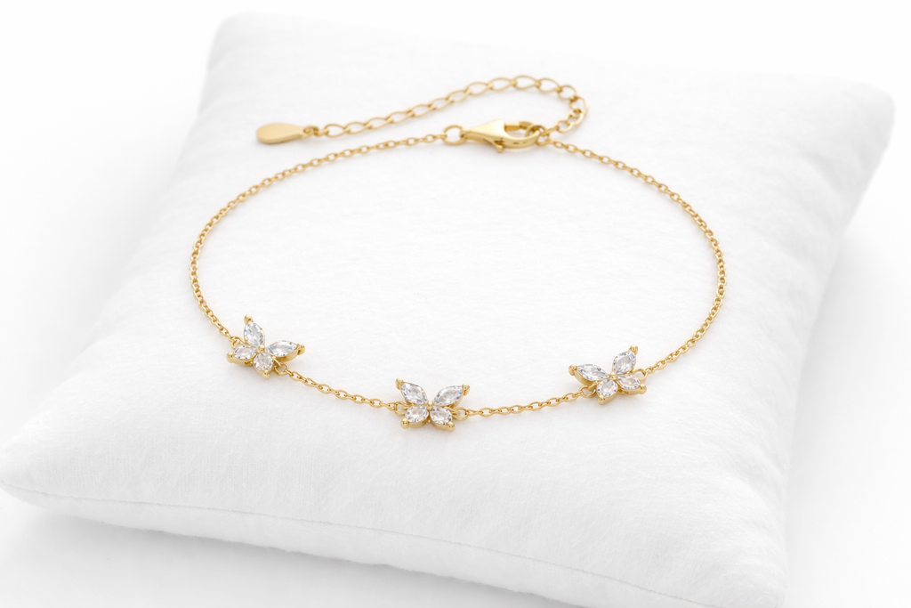 Gold bracelet with diamond-like stones on a white cushion