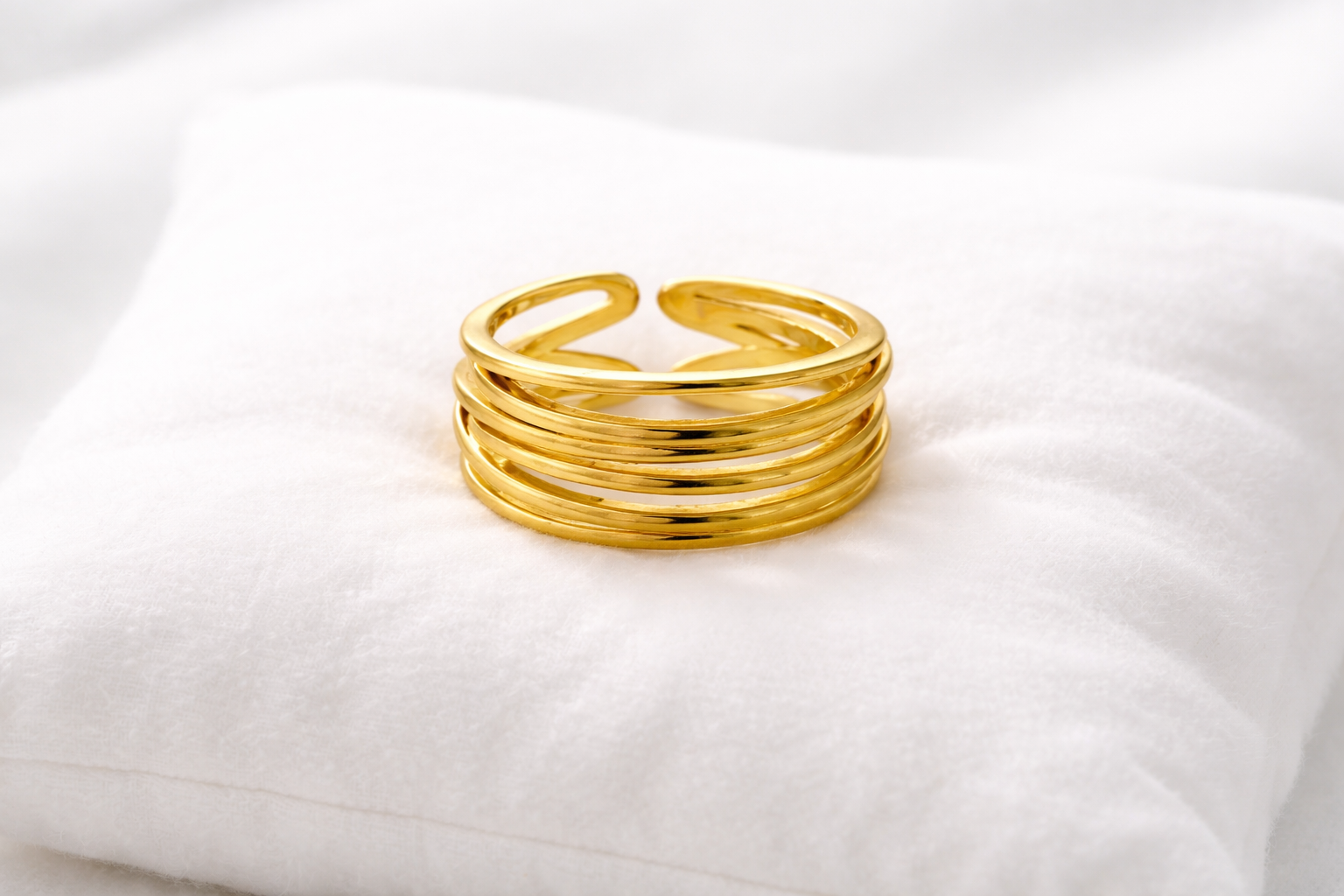 Gold ring on a white pillow