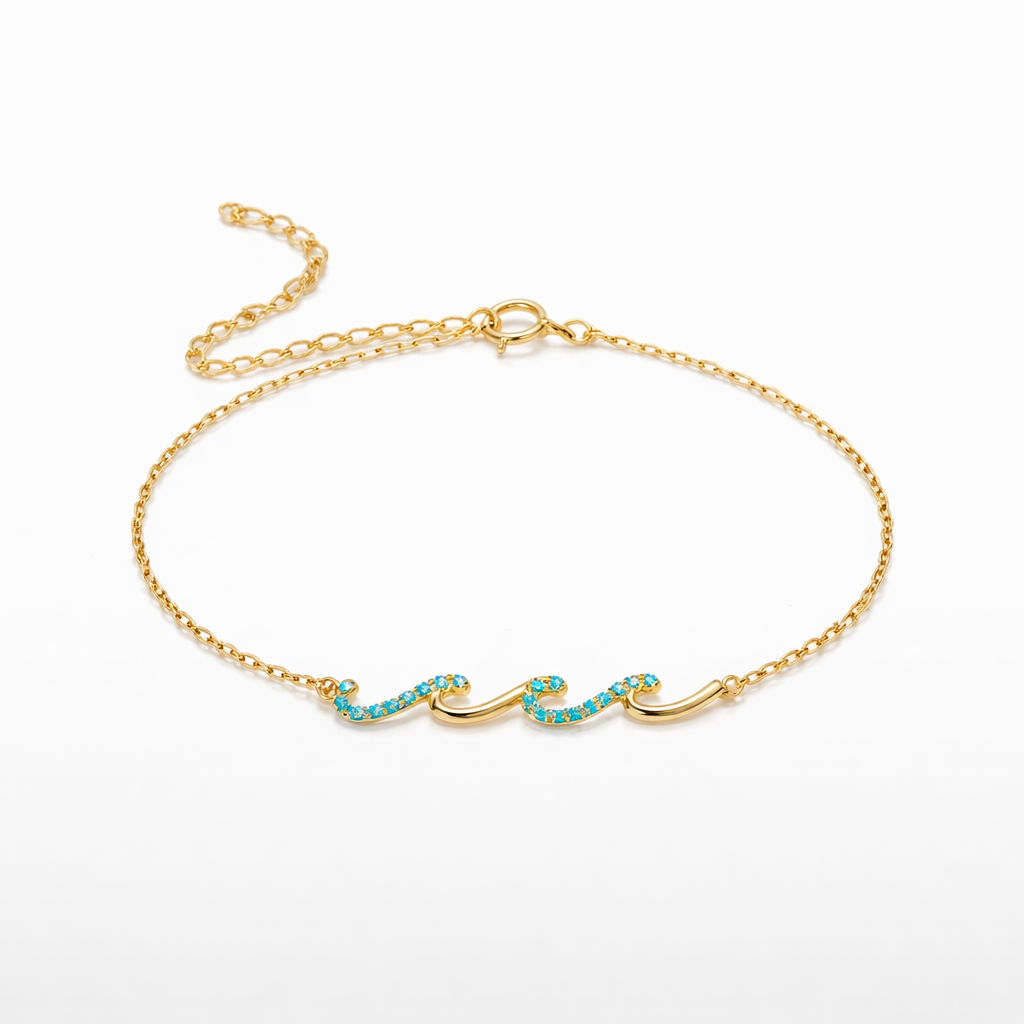 Gold bracelet with turquoise stones on a white background